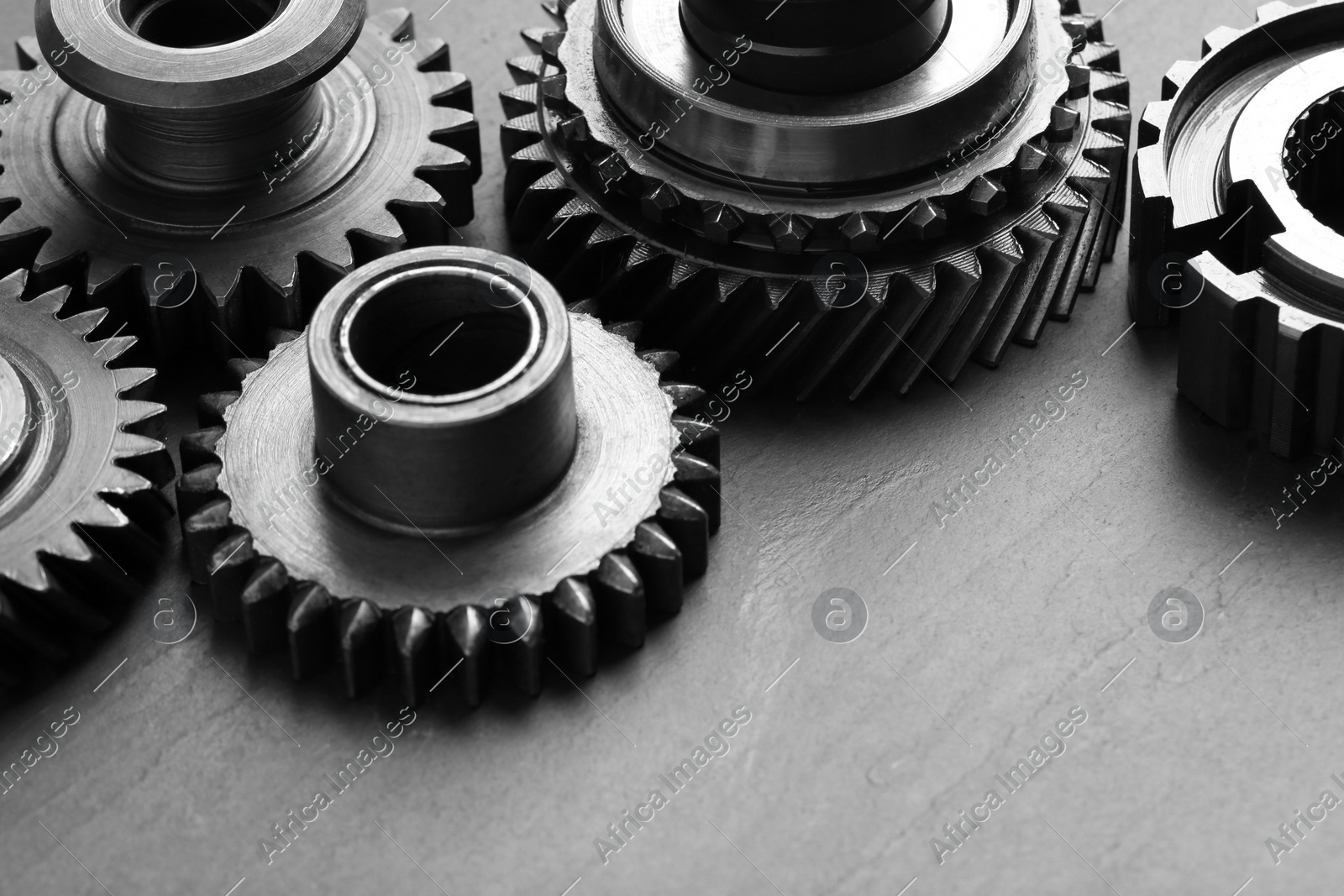 Different stainless steel gears on grey background, closeup Photo of Different stainless steel gears on grey background, closeup