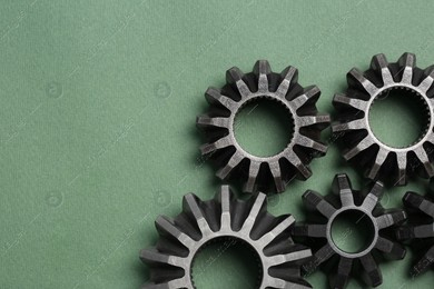 Different stainless steel gears on light green background, flat lay. Space for text Photo of Different stainless steel gears on light green background, flat lay. Space for text