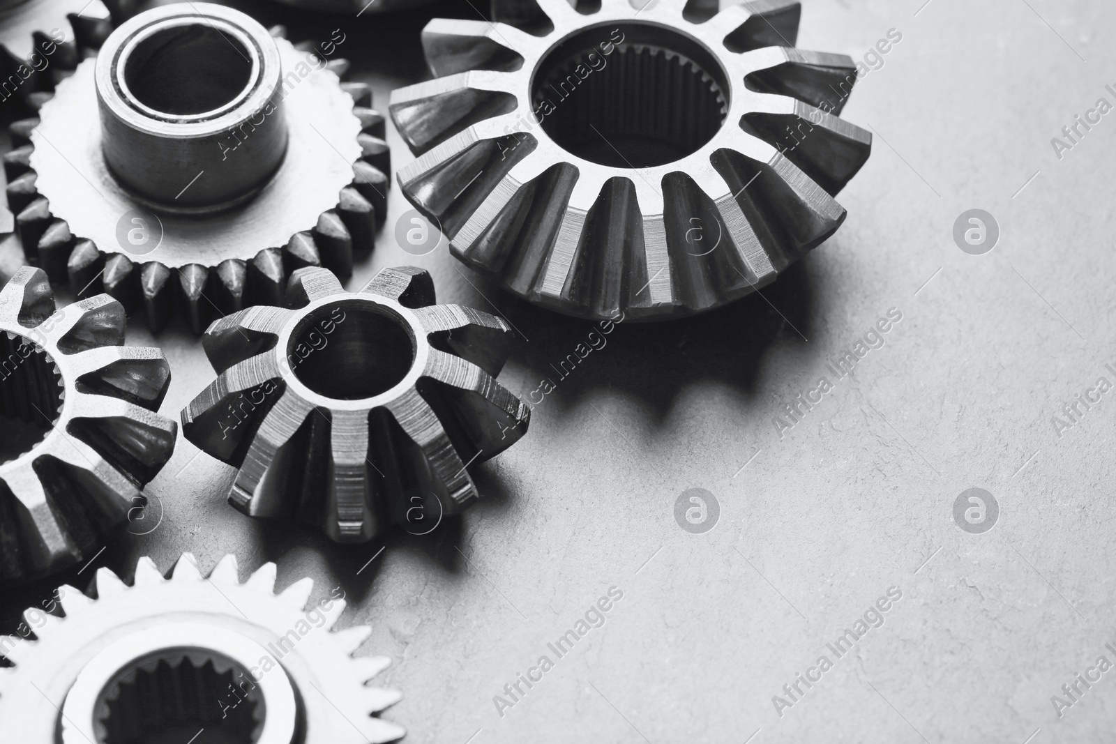 Different stainless steel gears on light grey background, closeup Photo of Different stainless steel gears on light grey background, closeup