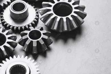 Different stainless steel gears on light grey background, closeup Photo of Different stainless steel gears on light grey background, closeup