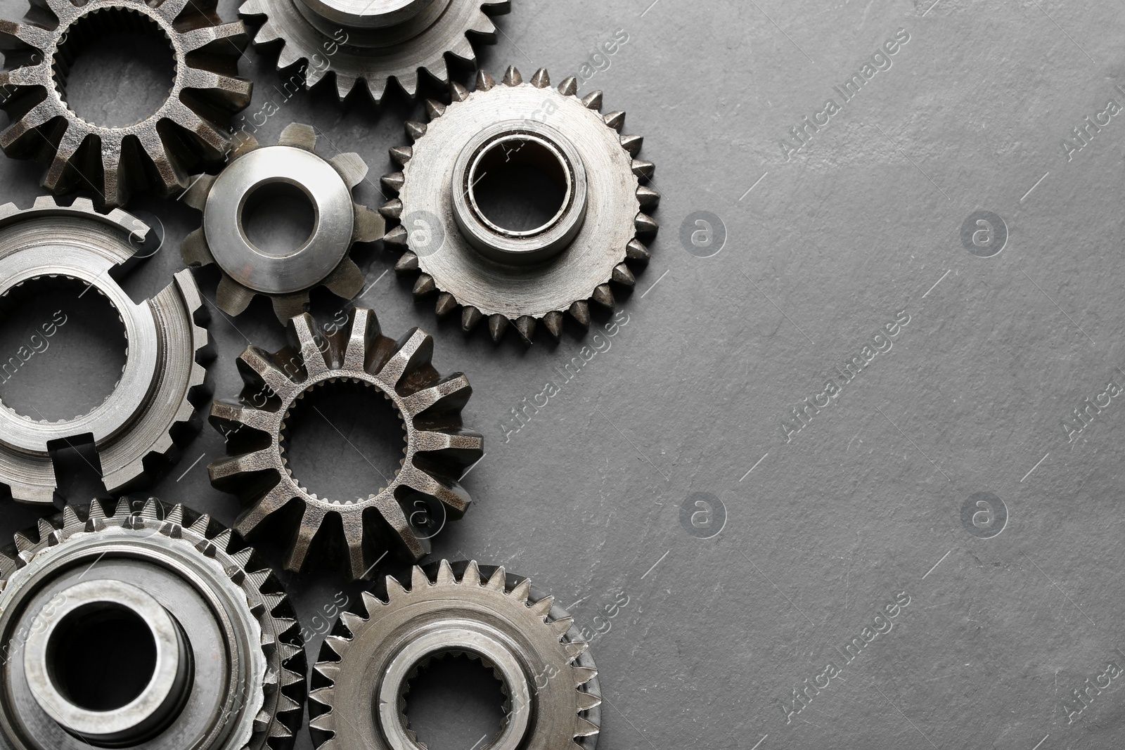 Different stainless steel gears on light grey background, flat lay. Space for text Photo of Different stainless steel gears on light grey background, flat lay. Space for text