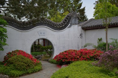 HAREN, NETHERLANDS - MAY 23, 2022: Beautiful view of Moon gate in Chinese garden Photo of HAREN, NETHERLANDS - MAY 23, 2022: Beautiful view of Moon gate in Chinese garden