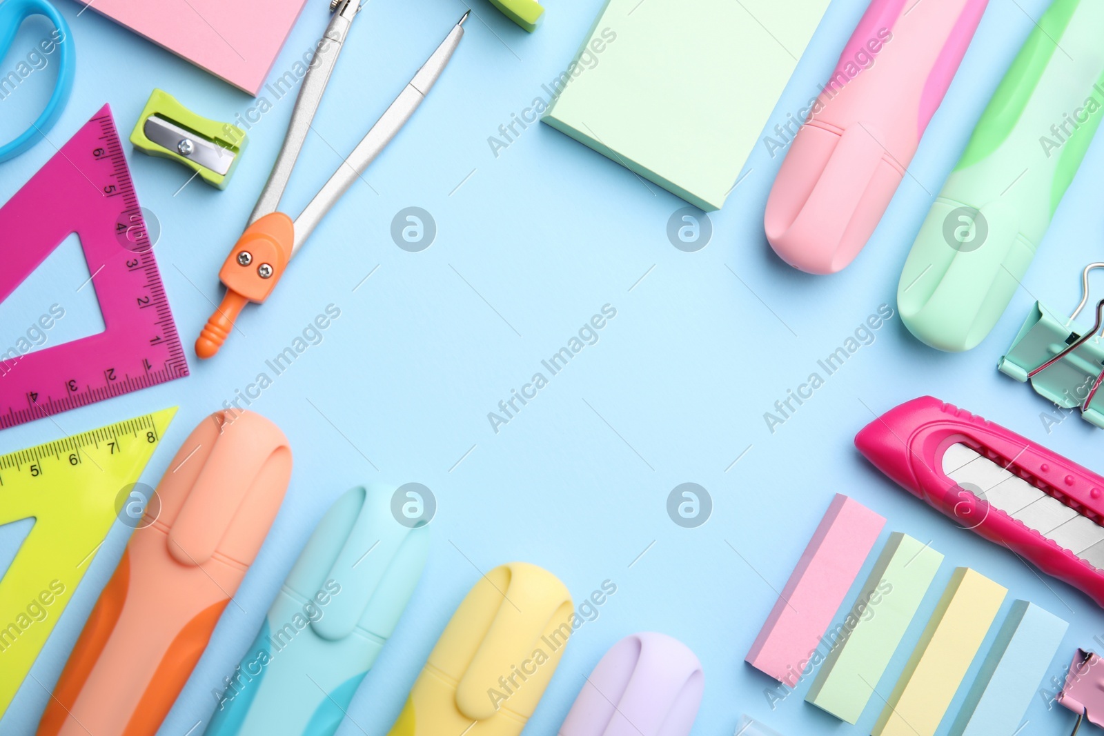 Photo of Frame of different school stationery on light blue background, flat lay. Back to school