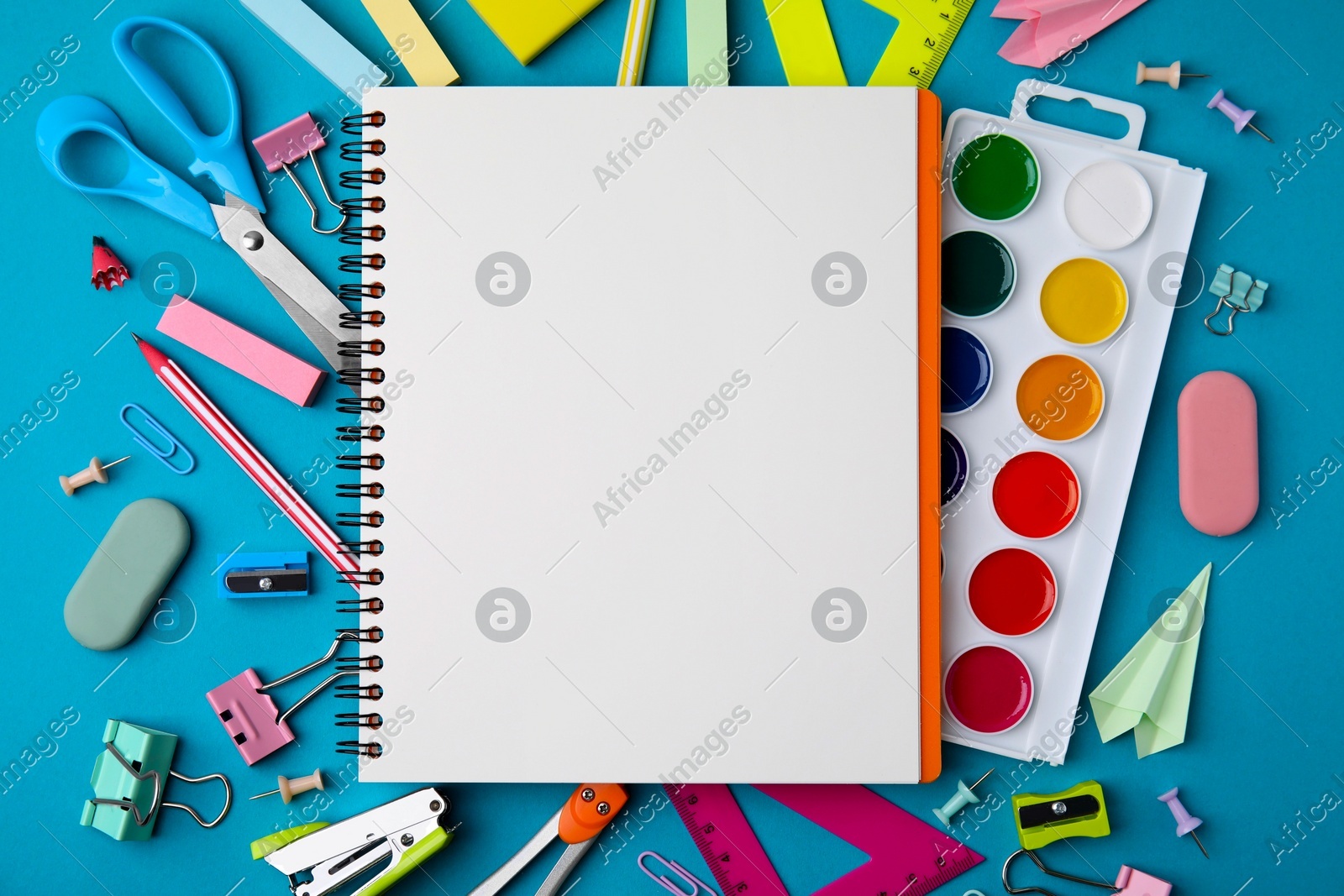 Different school stationery items and notebook on light blue background, flat lay with space for text. Back to school Photo of Different school stationery items and notebook on light blue background, flat lay with space for text. Back to school