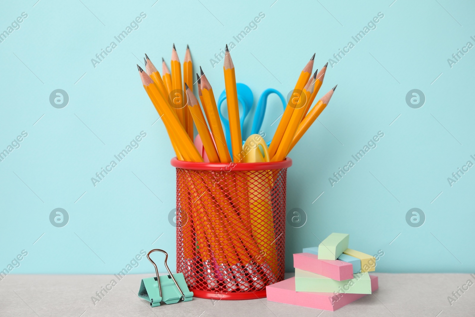 Different school stationery on table against light blue background. Back to school Photo of Different school stationery on table against light blue background. Back to school