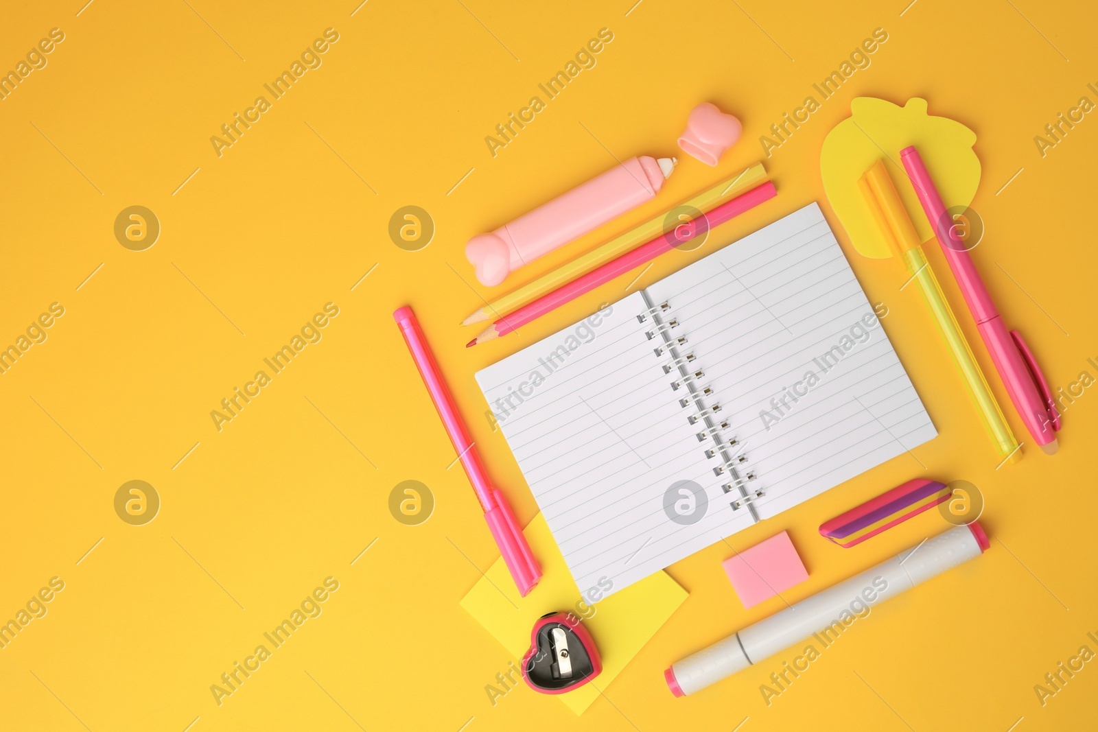 Flat lay composition with open notebook and different school stationery on yellow background, space for text. Back to school Photo of Flat lay composition with open notebook and different school stationery on yellow background, space for text. Back to school