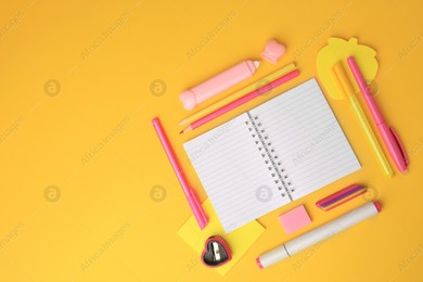 Flat lay composition with open notebook and different school stationery on yellow background, space for text. Back to school Photo of Flat lay composition with open notebook and different school stationery on yellow background, space for text. Back to school