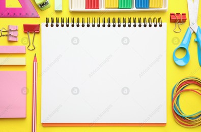 Flat lay composition with different school stationery on yellow background, space for text. Back to school Photo of Flat lay composition with different school stationery on yellow background, space for text. Back to school