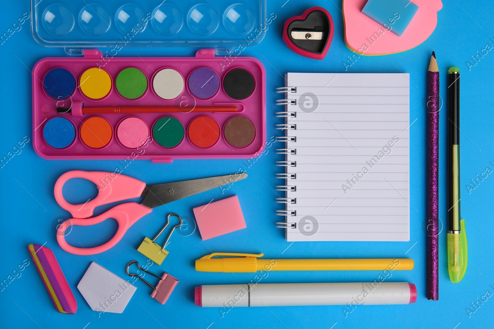 Flat lay composition with blank notebook and other school stationery on light blue background, space for text. Back to school Photo of Flat lay composition with blank notebook and other school stationery on light blue background, space for text. Back to school
