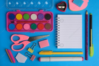 Flat lay composition with blank notebook and other school stationery on light blue background, space for text. Back to school Photo of Flat lay composition with blank notebook and other school stationery on light blue background, space for text. Back to school