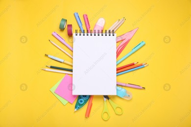 Flat lay composition with blank notebook and different school stationery on yellow background, space for text. Back to school Photo of Flat lay composition with blank notebook and different school stationery on yellow background, space for text. Back to school
