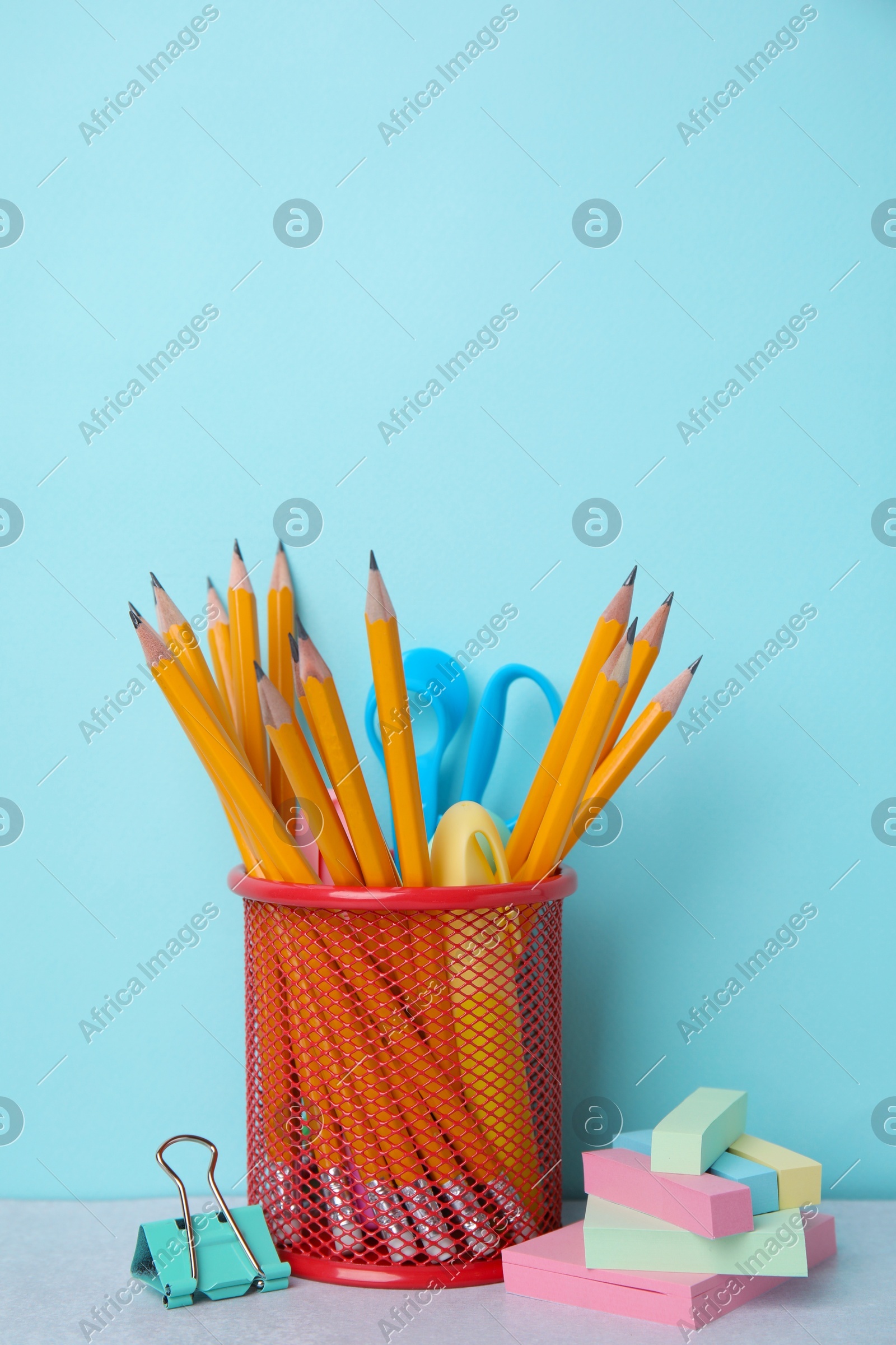 Different school stationery on table against light blue background. Back to school Photo of Different school stationery on table against light blue background. Back to school