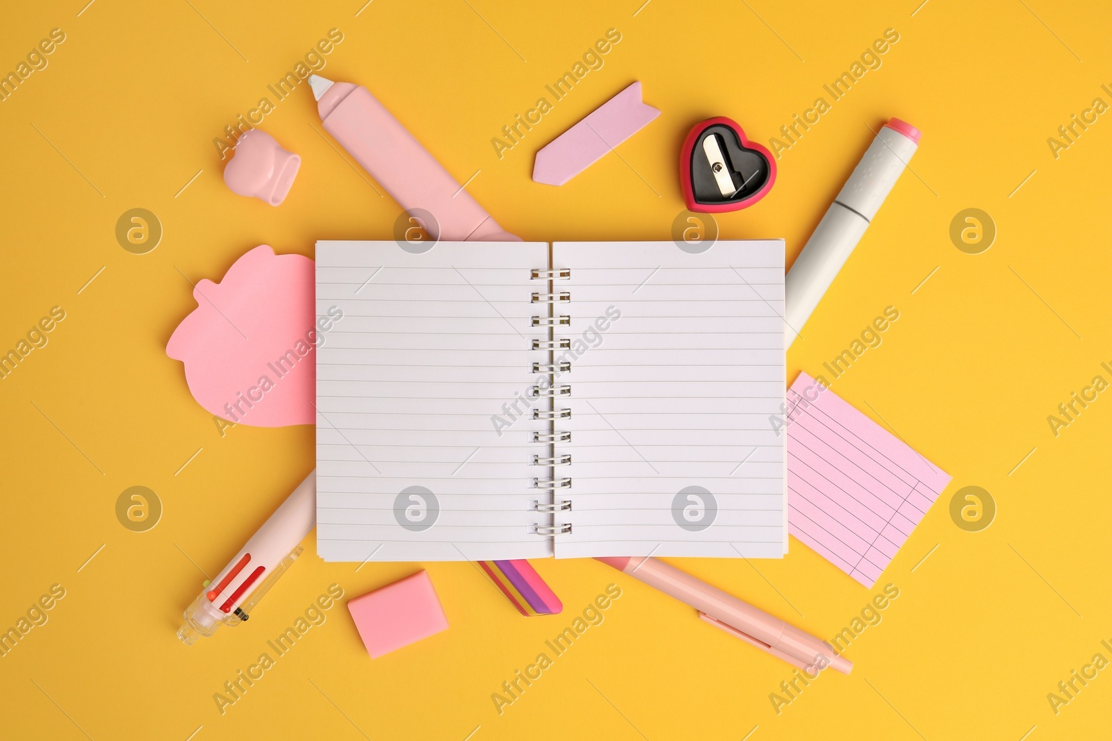 Flat lay composition with open notebook and different school stationery on yellow background, space for text. Back to school Photo of Flat lay composition with open notebook and different school stationery on yellow background, space for text. Back to school