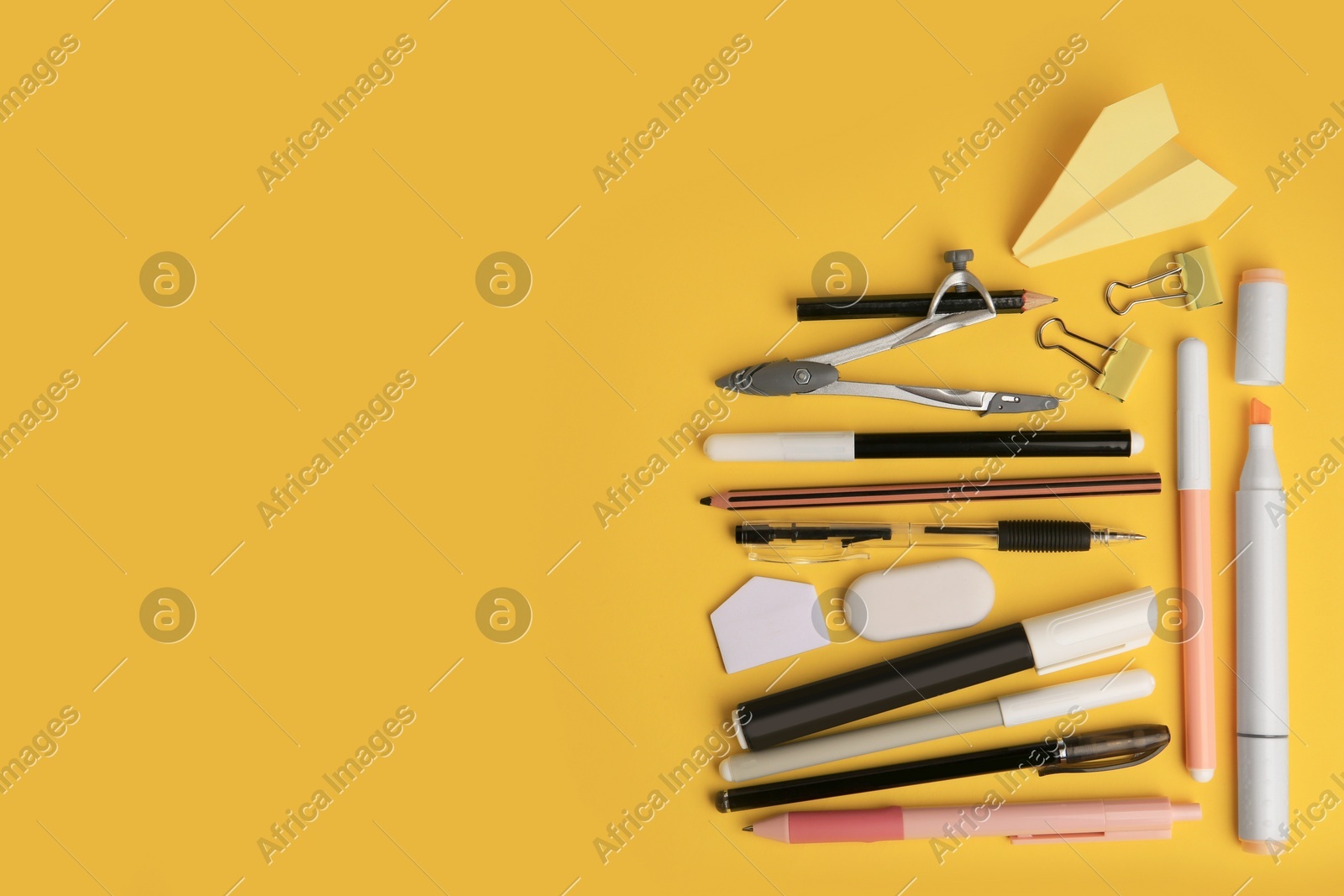 Flat lay composition with paper plane and different school stationery on orange background, space for text. Back to school Photo of Flat lay composition with paper plane and different school stationery on orange background, space for text. Back to school