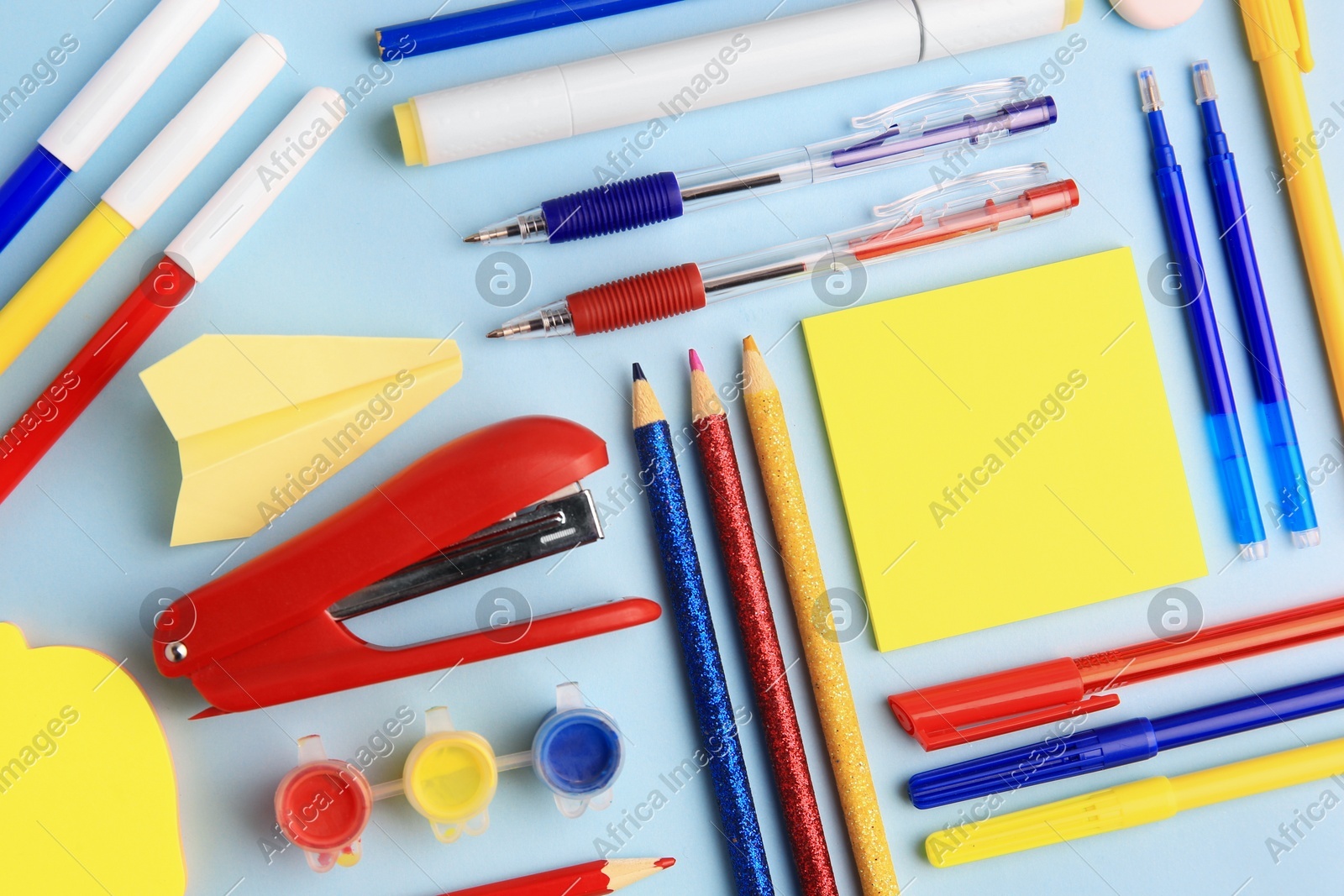 Flat lay composition with sticky note and other school stationery on light blue background, space for text. Back to school Photo of Flat lay composition with sticky note and other school stationery on light blue background, space for text. Back to school