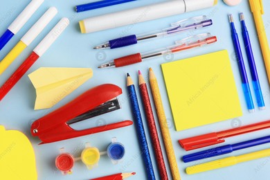 Flat lay composition with sticky note and other school stationery on light blue background, space for text. Back to school Photo of Flat lay composition with sticky note and other school stationery on light blue background, space for text. Back to school