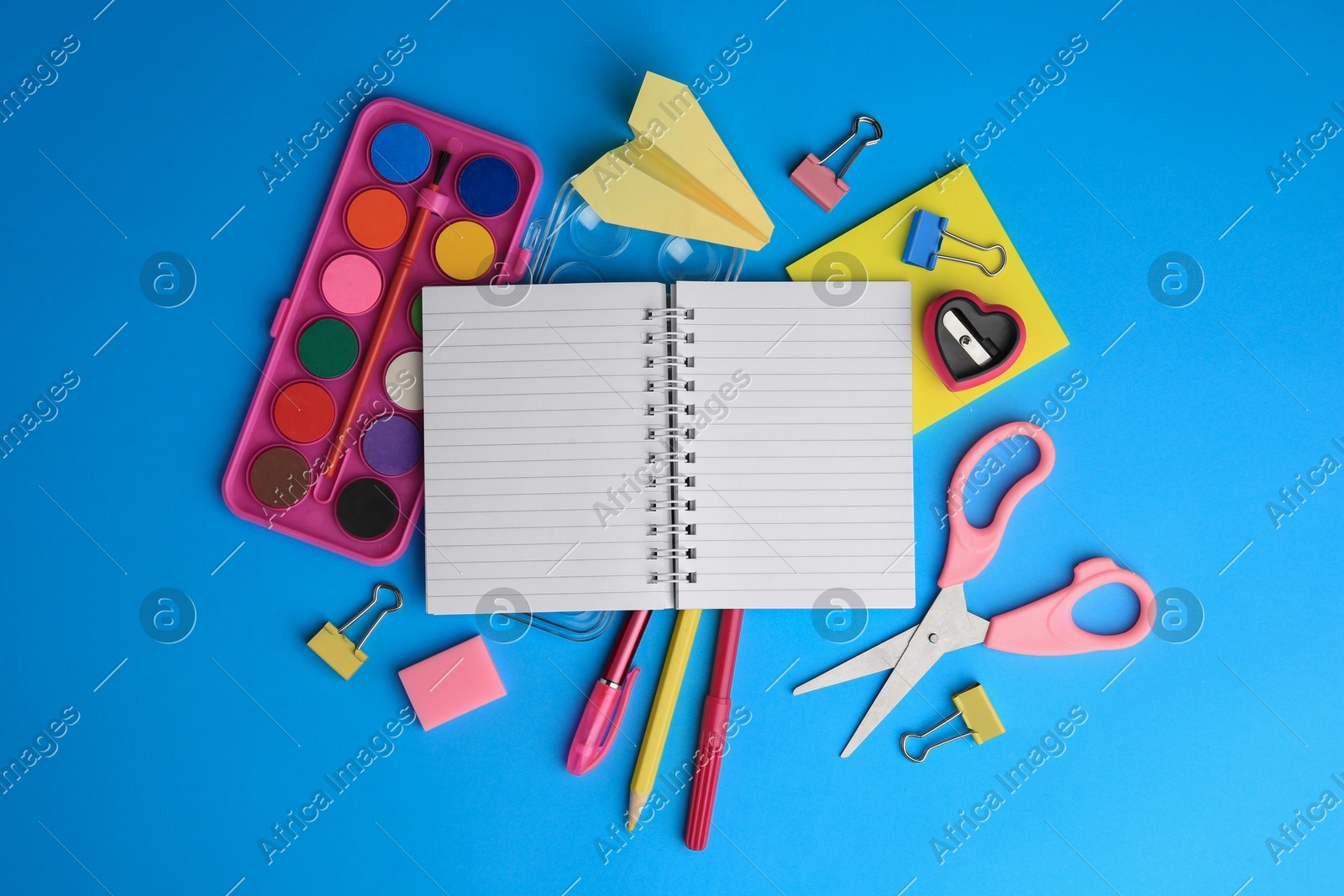 Flat lay composition with blank notebook and other school stationery on light blue background, space for text. Back to school Photo of Flat lay composition with blank notebook and other school stationery on light blue background, space for text. Back to school
