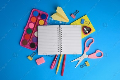 Flat lay composition with blank notebook and other school stationery on light blue background, space for text. Back to school Photo of Flat lay composition with blank notebook and other school stationery on light blue background, space for text. Back to school