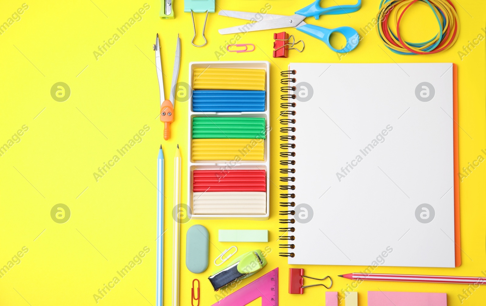Flat lay composition with different school stationery on yellow background, space for text. Back to school Photo of Flat lay composition with different school stationery on yellow background, space for text. Back to school