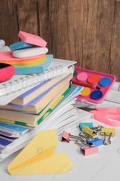 Many different books, paper plane and school stationery on white table. Back to school Photo of Many different books, paper plane and school stationery on white table. Back to school