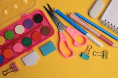 Flat lay composition with notebook and other school stationery on orange background. Back to school Photo of Flat lay composition with notebook and other school stationery on orange background. Back to school