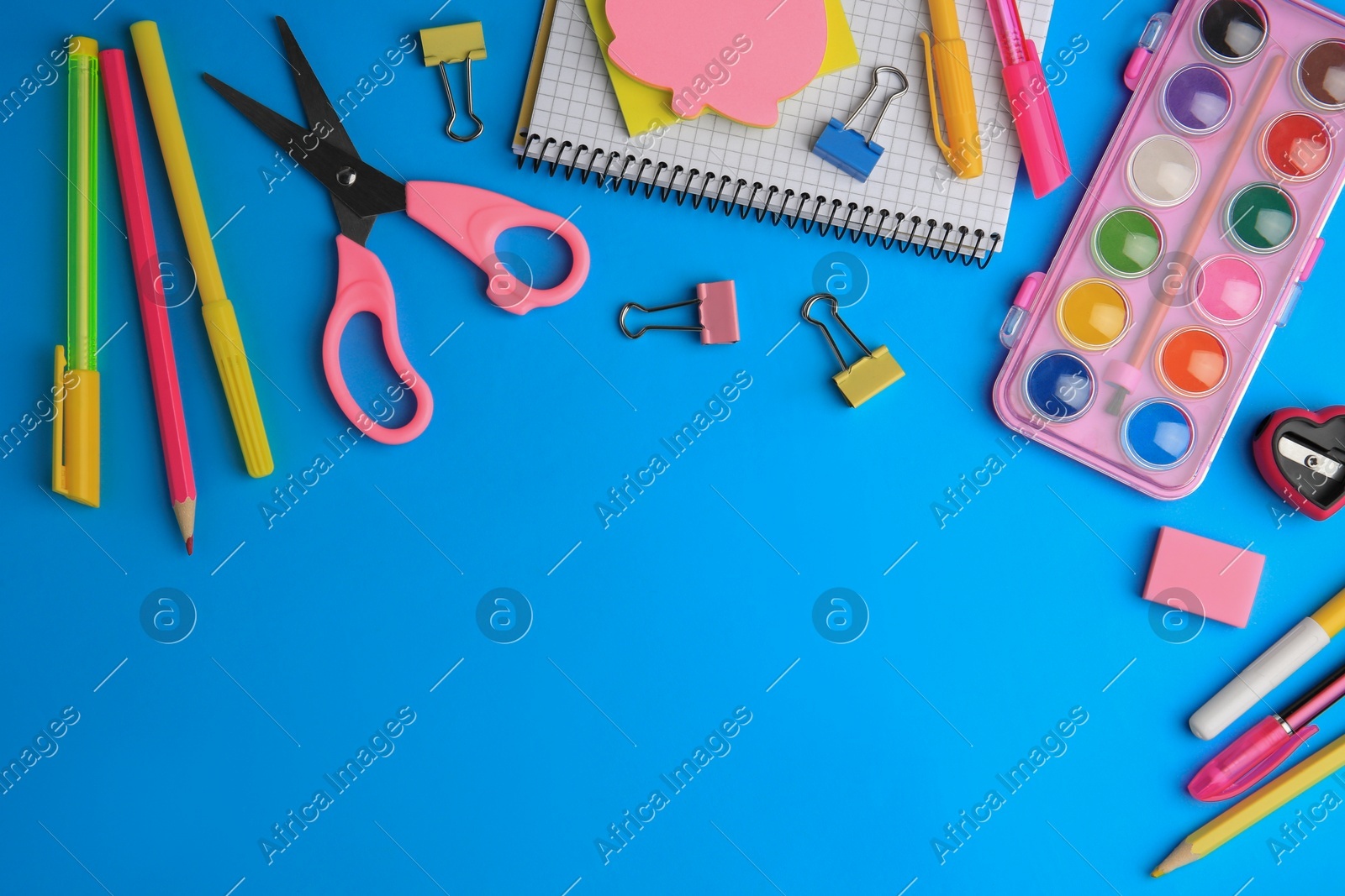 Flat lay composition with notebook and other school stationery on light blue background, space for text. Back to school Photo of Flat lay composition with notebook and other school stationery on light blue background, space for text. Back to school