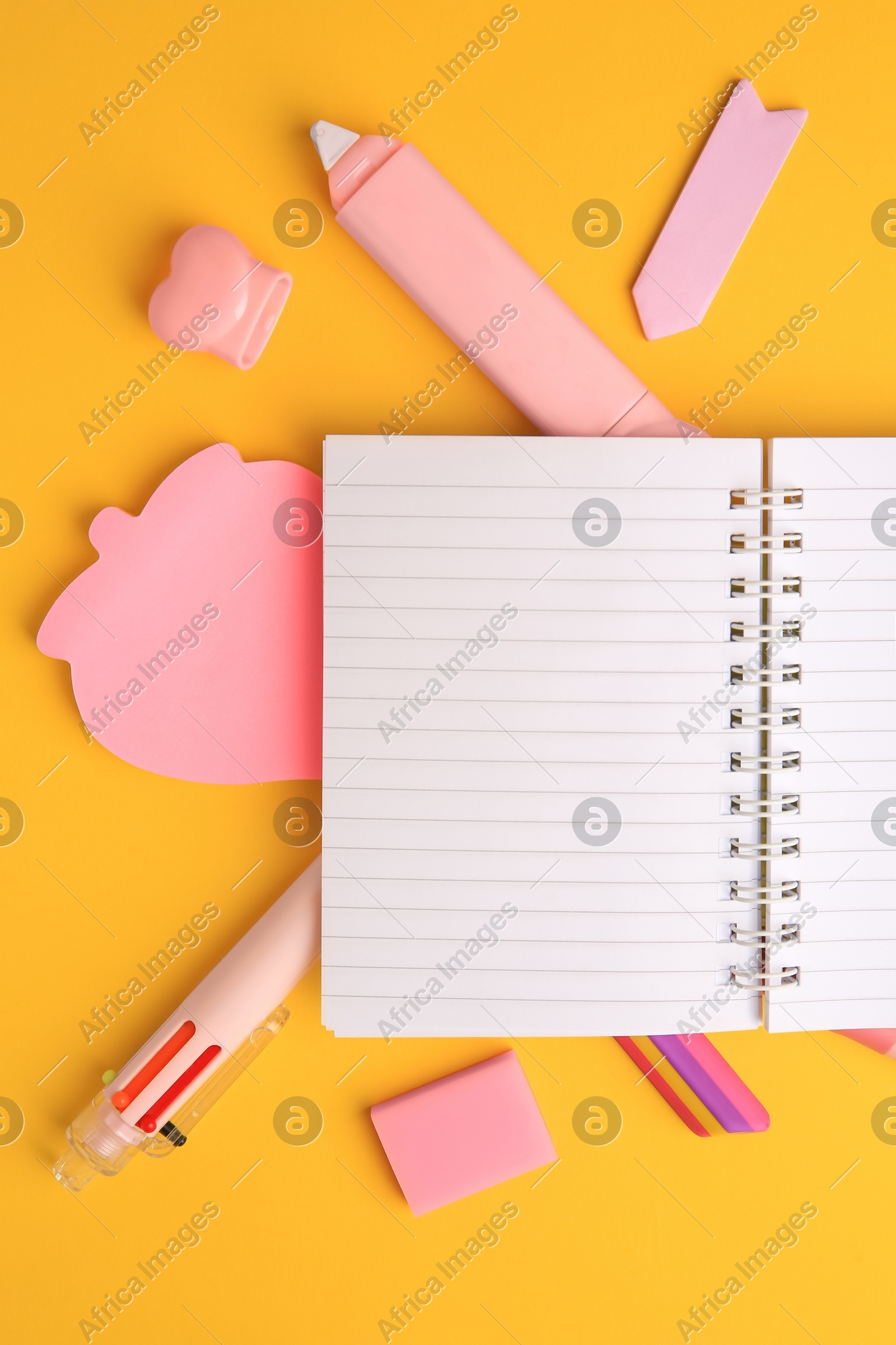 Flat lay composition with open notebook and different school stationery on yellow background, space for text. Back to school Photo of Flat lay composition with open notebook and different school stationery on yellow background, space for text. Back to school