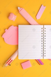 Flat lay composition with open notebook and different school stationery on yellow background, space for text. Back to school Photo of Flat lay composition with open notebook and different school stationery on yellow background, space for text. Back to school