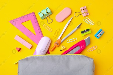 Flat lay composition with different school stationery on yellow background. Back to school Photo of Flat lay composition with different school stationery on yellow background. Back to school