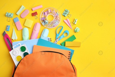 Flat lay composition with different school stationery on yellow background. Back to school Photo of Flat lay composition with different school stationery on yellow background. Back to school