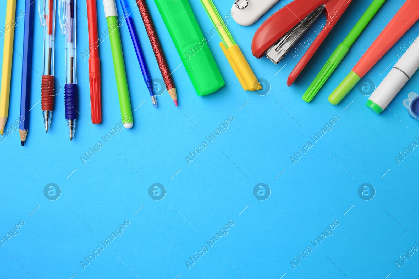 Flat lay composition with different school stationery on light blue background, space for text. Back to school Photo of Flat lay composition with different school stationery on light blue background, space for text. Back to school