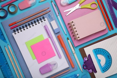 Flat lay composition with notebooks and other school stationery on light blue background. Back to school Photo of Flat lay composition with notebooks and other school stationery on light blue background. Back to school