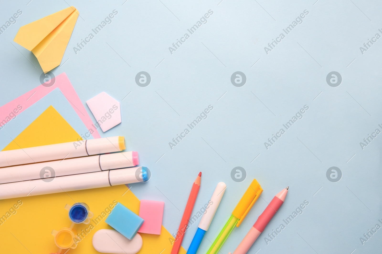Flat lay composition with different school stationery on light blue background, space for text. Back to school Photo of Flat lay composition with different school stationery on light blue background, space for text. Back to school