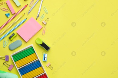 Flat lay composition with different school stationery on pale yellow background, space for text. Back to school Photo of Flat lay composition with different school stationery on pale yellow background, space for text. Back to school