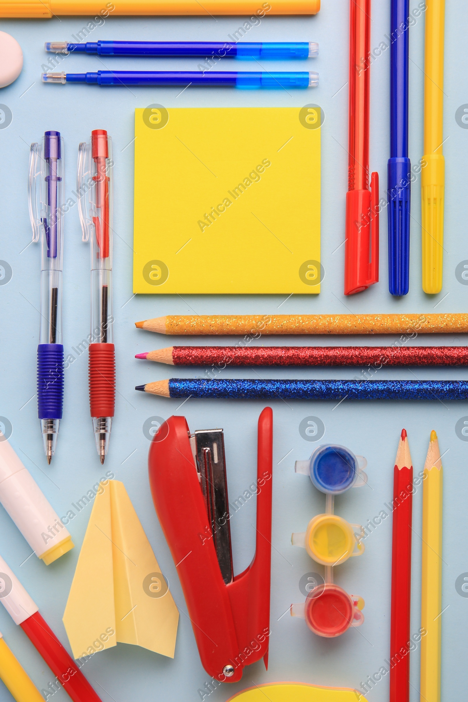 Flat lay composition with sticky note and other school stationery on light blue background, space for text. Back to school Photo of Flat lay composition with sticky note and other school stationery on light blue background, space for text. Back to school