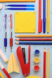 Flat lay composition with sticky note and other school stationery on light blue background, space for text. Back to school Photo of Flat lay composition with sticky note and other school stationery on light blue background, space for text. Back to school