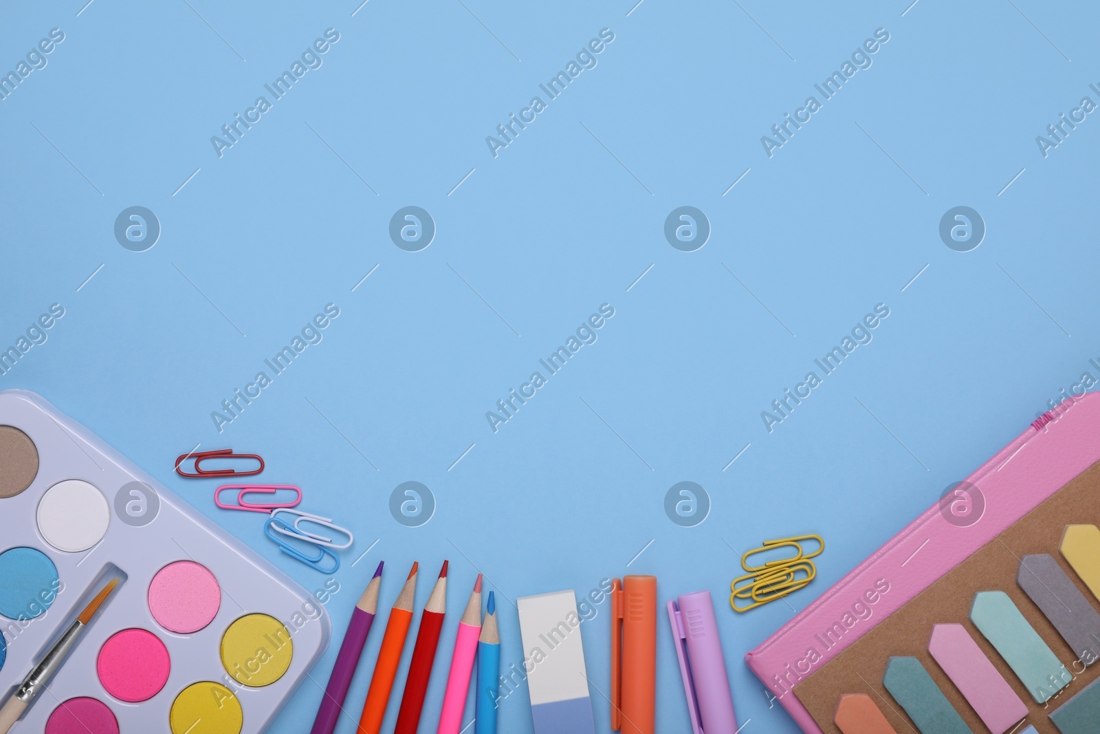 Flat lay composition with different school stationery on light blue background, space for text. Back to school Photo of Flat lay composition with different school stationery on light blue background, space for text. Back to school