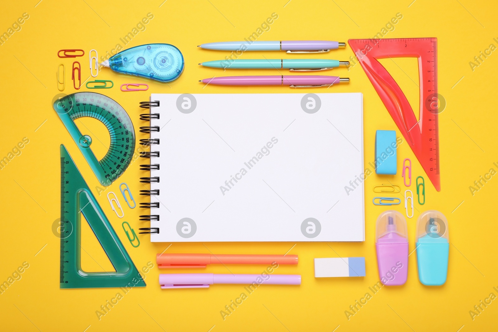 Flat lay composition with notebook and other school stationery on yellow background, space for text. Back to school Photo of Flat lay composition with notebook and other school stationery on yellow background, space for text. Back to school