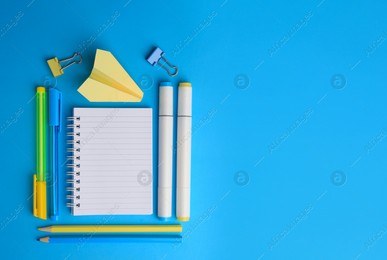 Paper plane and different school stationery on light blue background, flat lay with space for text. Back to school Photo of Paper plane and different school stationery on light blue background, flat lay with space for text. Back to school