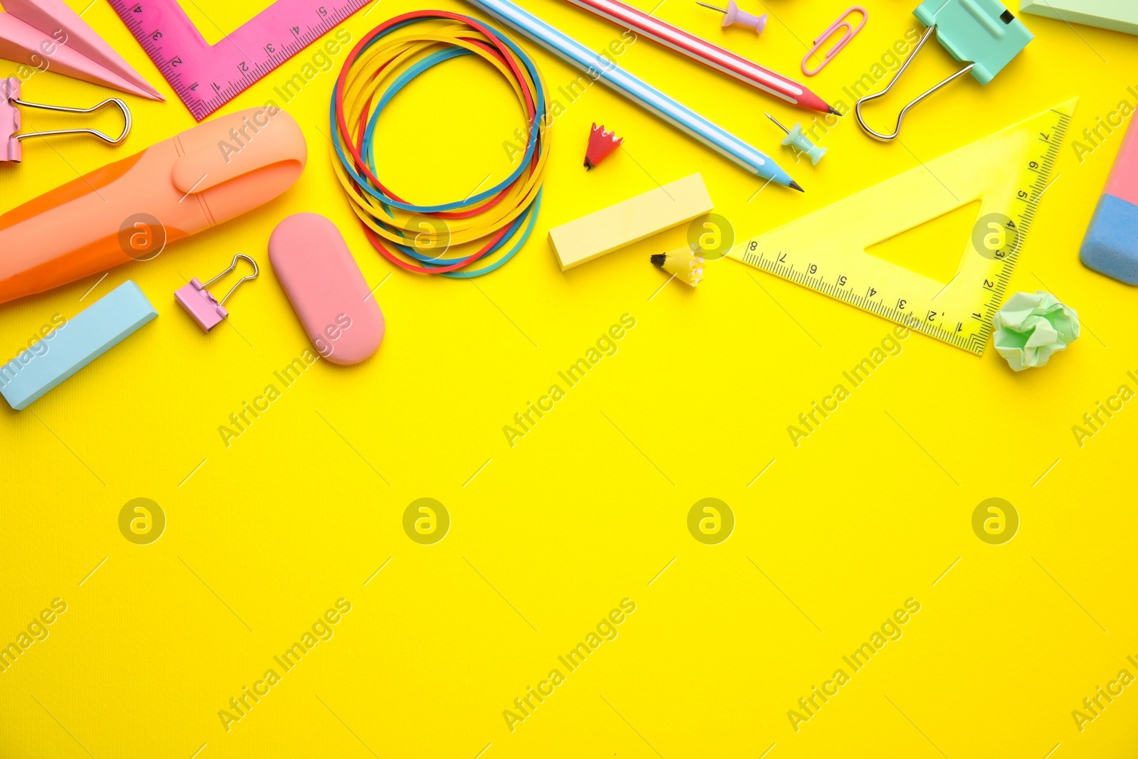 Flat lay composition with different school stationery on yellow background, space for text. Back to school Photo of Flat lay composition with different school stationery on yellow background, space for text. Back to school