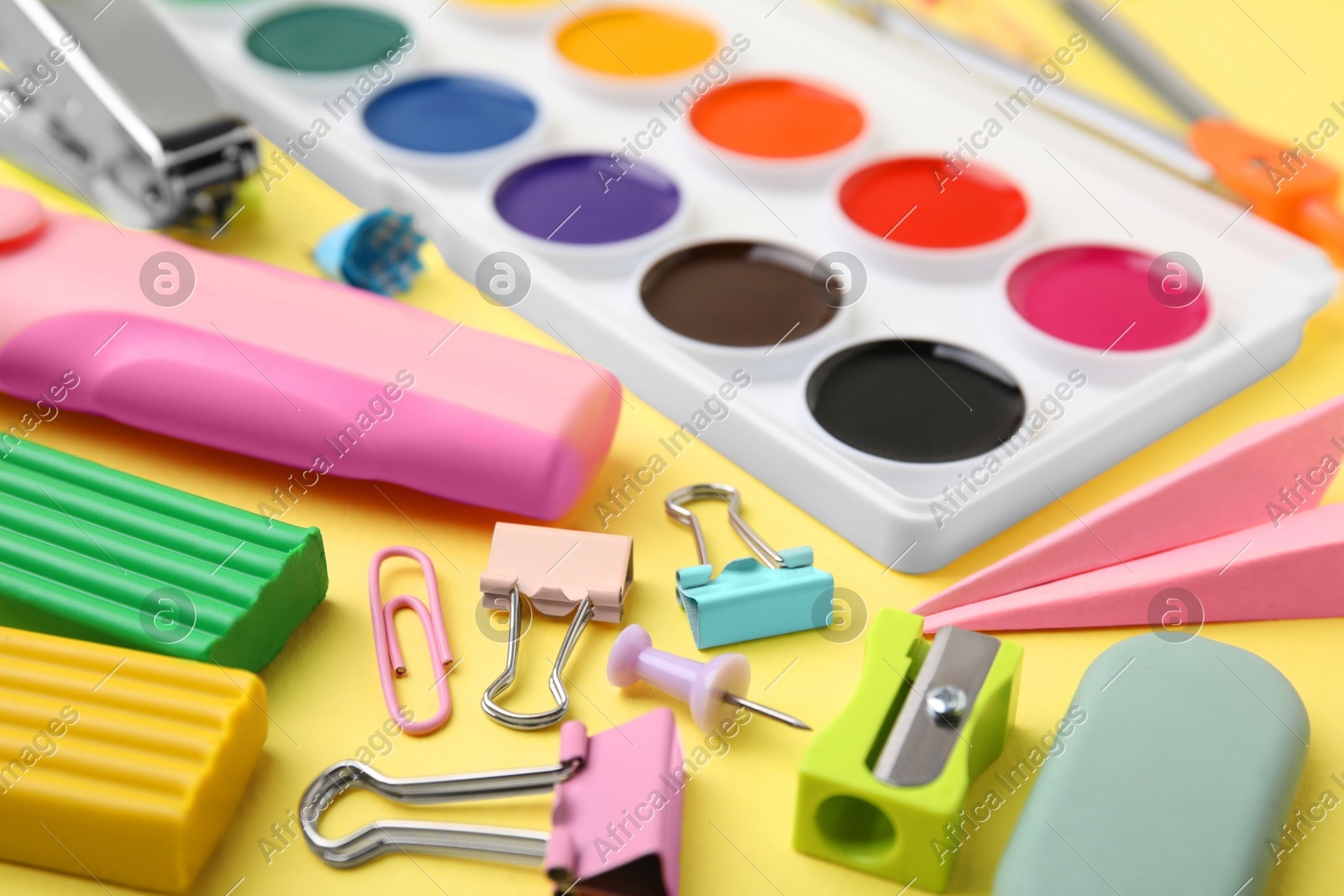 Many different school stationery on pale yellow background, closeup. Back to school Photo of Many different school stationery on pale yellow background, closeup. Back to school