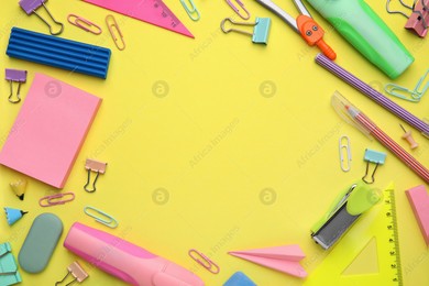 Flat lay composition with different school stationery on pale yellow background, space for text. Back to school Photo of Flat lay composition with different school stationery on pale yellow background, space for text. Back to school