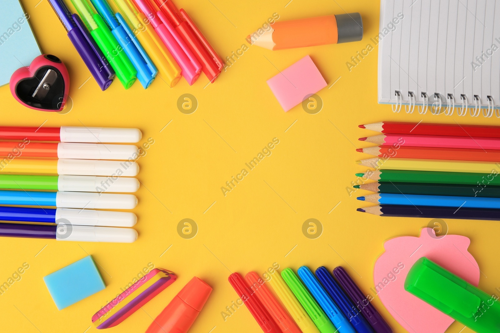 Frame made of different school stationery on yellow background, flat lay and space for text. Back to school Photo of Frame made of different school stationery on yellow background, flat lay and space for text. Back to school