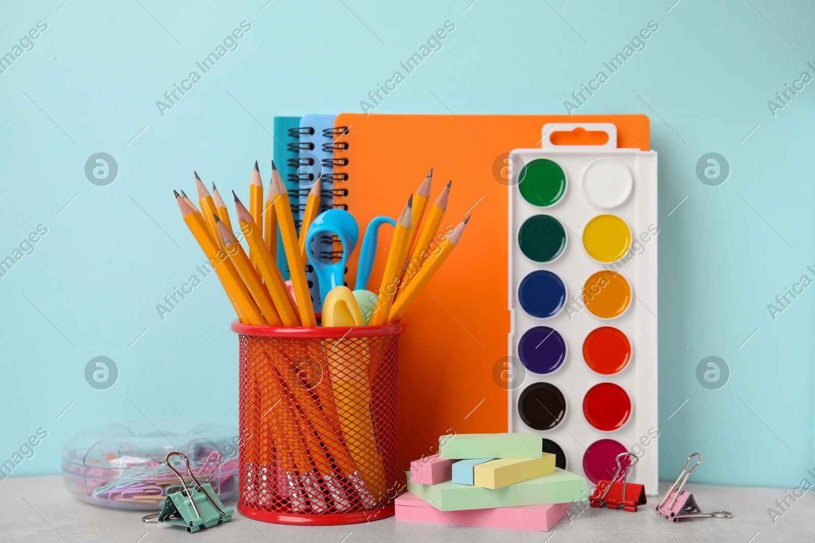 Different school stationery on table against light blue background. Back to school Photo of Different school stationery on table against light blue background. Back to school