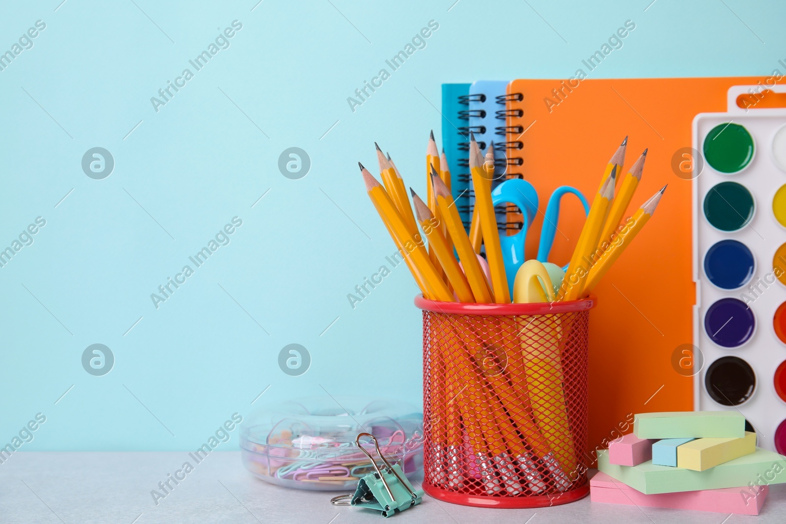 Different school stationery on table against light blue background, space for text. Back to school Photo of Different school stationery on table against light blue background, space for text. Back to school