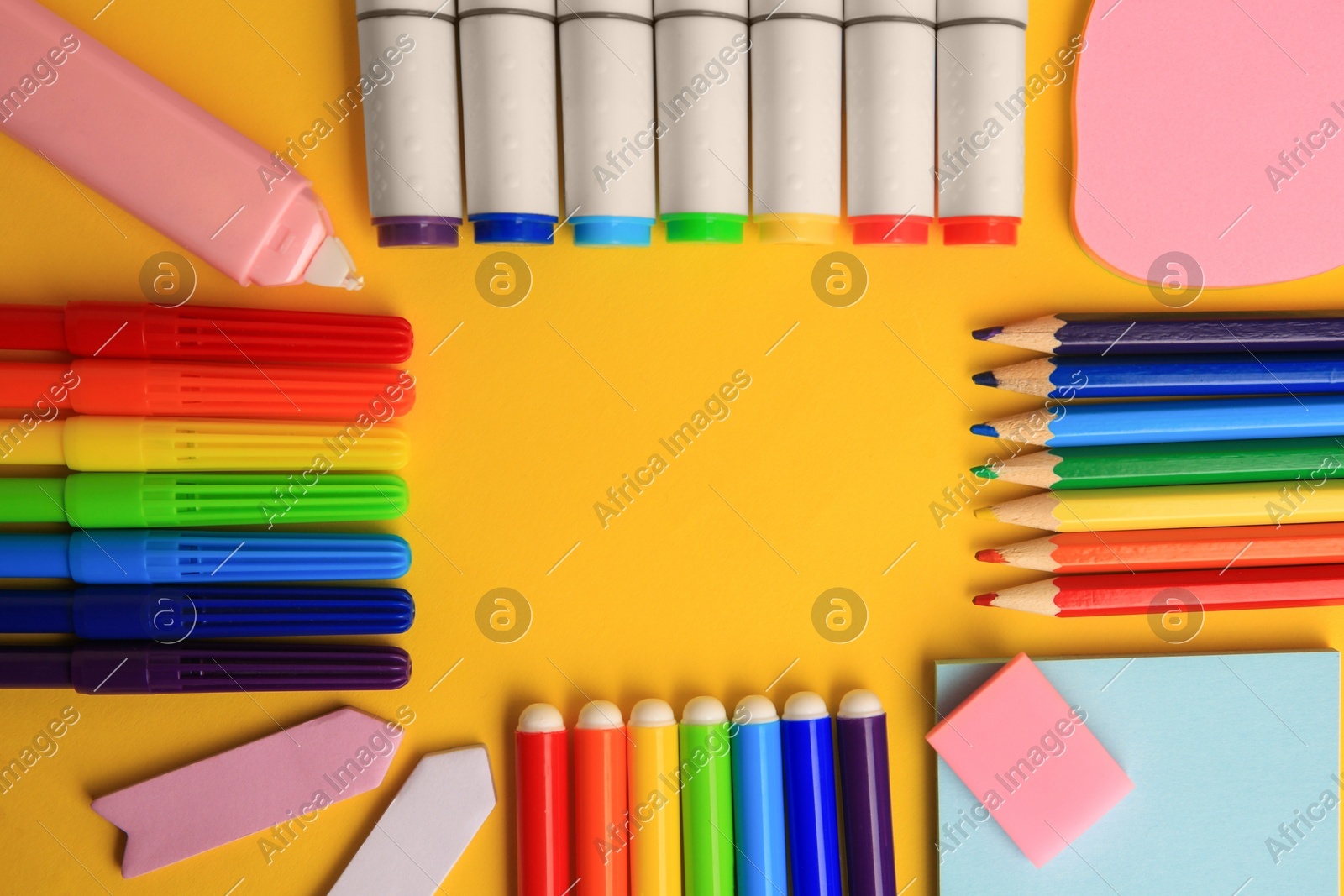 Frame of different school stationery on yellow background, flat lay with space for text. Back to school Photo of Frame of different school stationery on yellow background, flat lay with space for text. Back to school