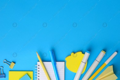 Paper plane and different school stationery on light blue background, flat lay with space for text. Back to school Photo of Paper plane and different school stationery on light blue background, flat lay with space for text. Back to school