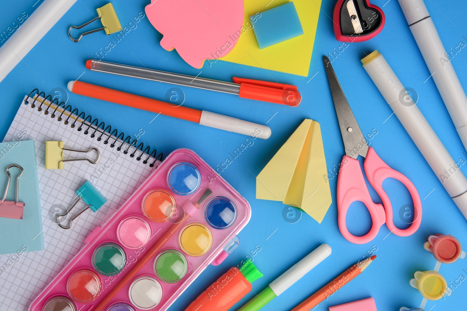 Flat lay composition with notebook and other school stationery on light blue background. Back to school Photo of Flat lay composition with notebook and other school stationery on light blue background. Back to school