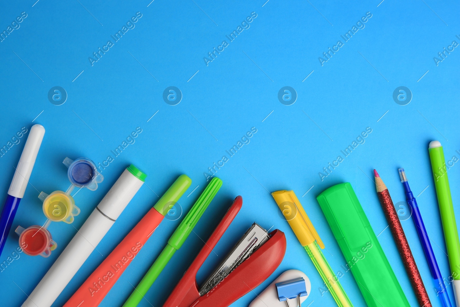 Flat lay composition with different school stationery on light blue background, space for text. Back to school Photo of Flat lay composition with different school stationery on light blue background, space for text. Back to school