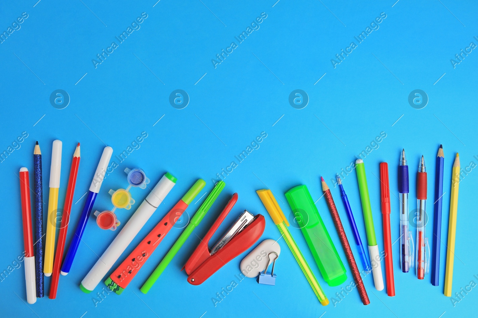 Flat lay composition with different school stationery on light blue background, space for text. Back to school Photo of Flat lay composition with different school stationery on light blue background, space for text. Back to school